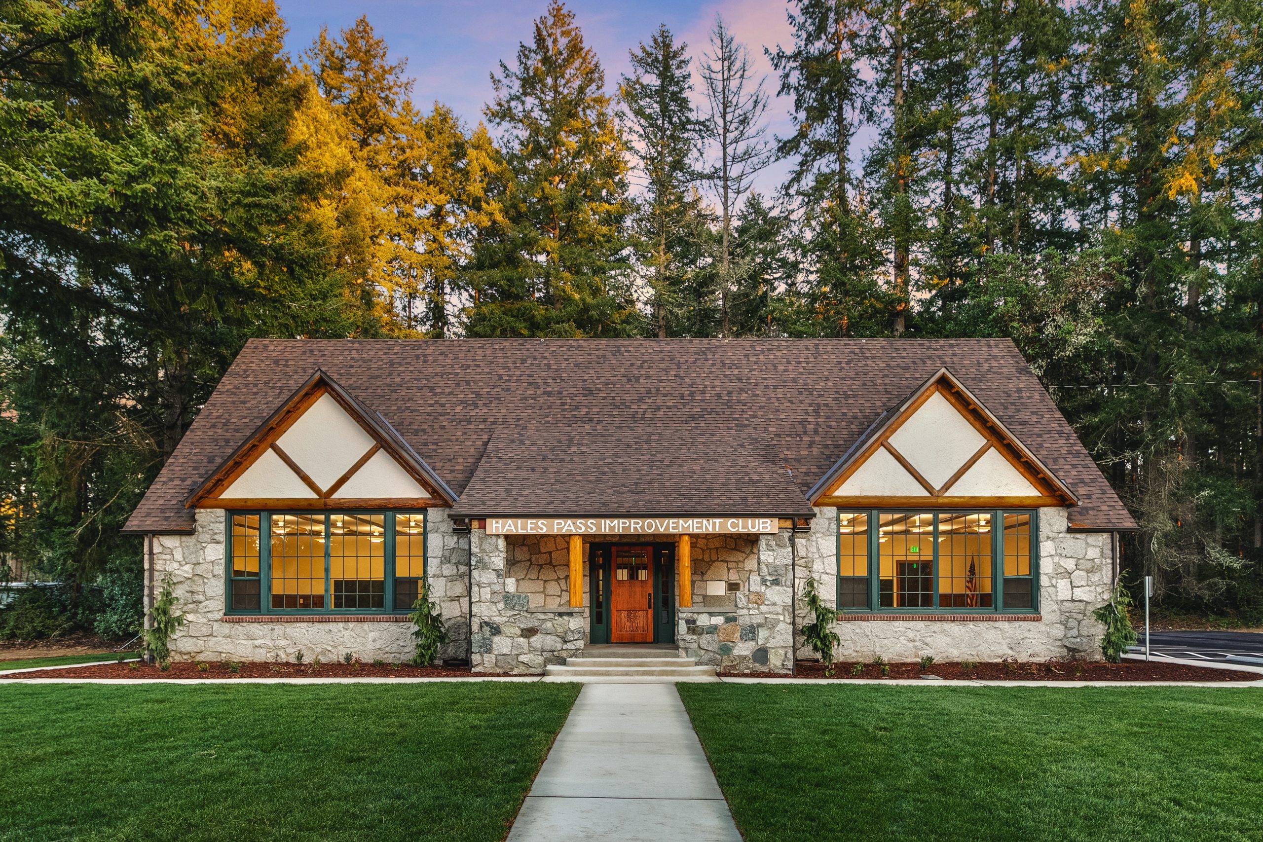 The front facade and entry is flanked by new landscape plants laid out symmetrically