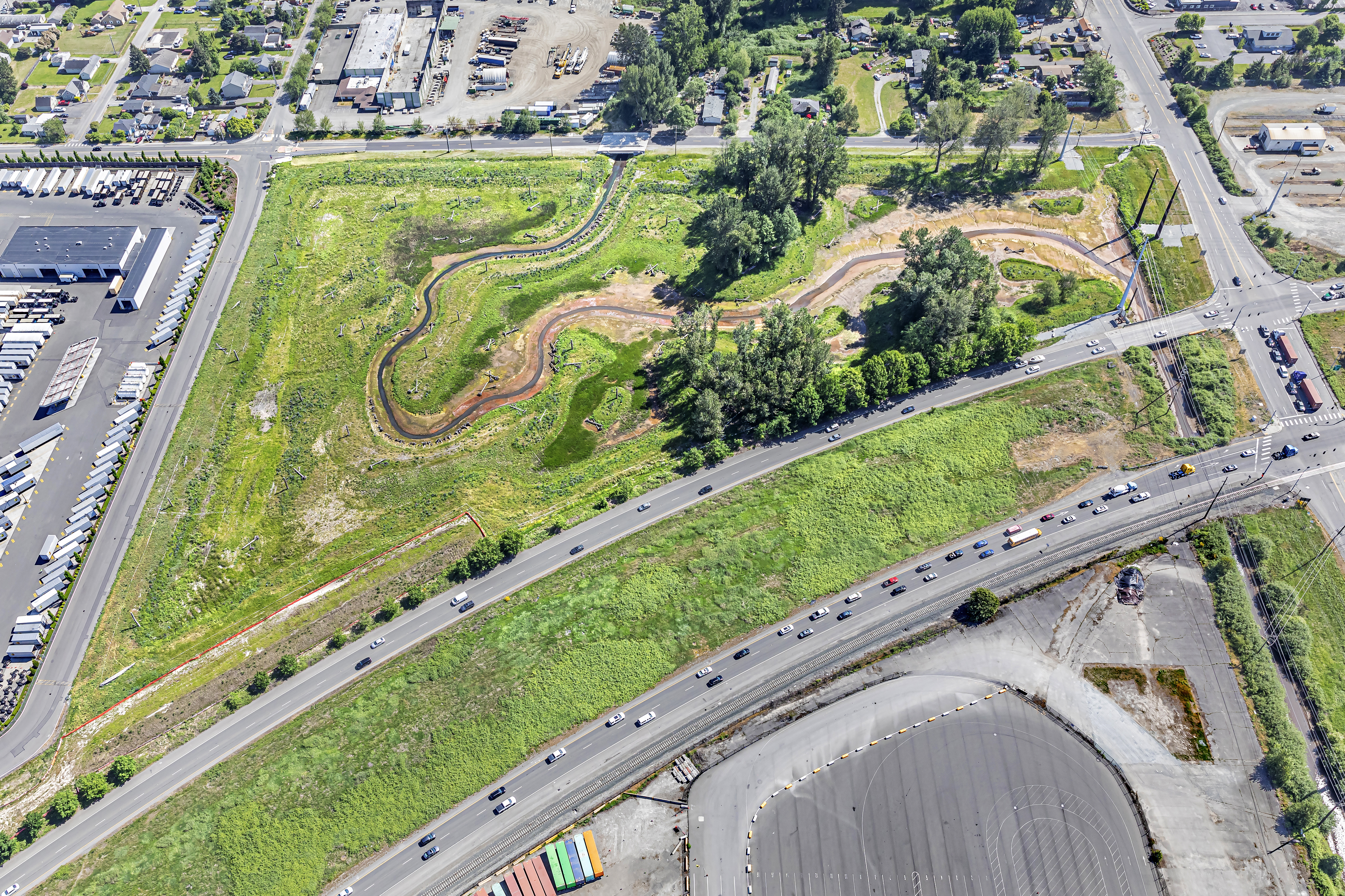 The site sits adjacent to major arterials and is bordered by collector streets within a broader industrial and residential context