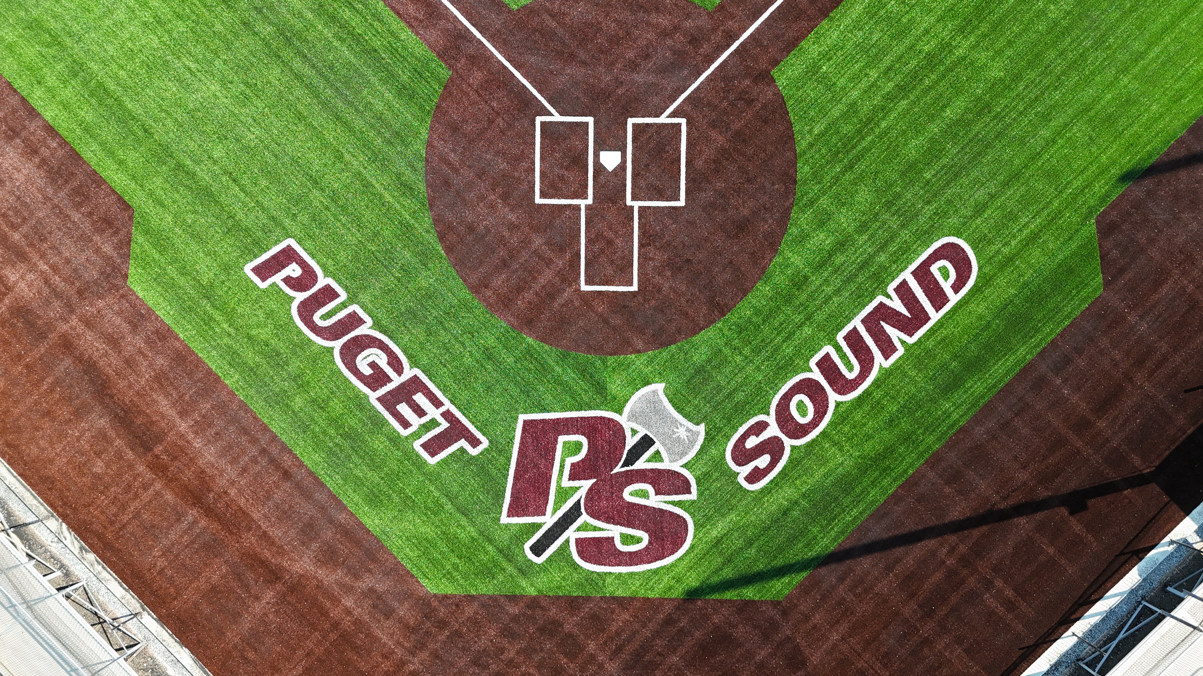 Zoomed view of Puget Sound Loggers logo behind home plate